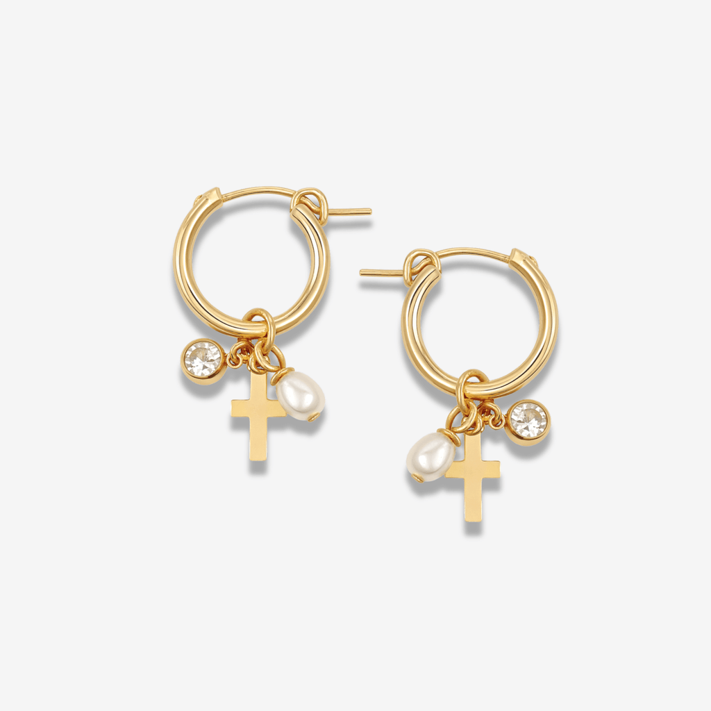 Gold 15mm hoop earrings with three small dangling charms: a CZ stone, a freshwater pearl, and a mini gold cross.