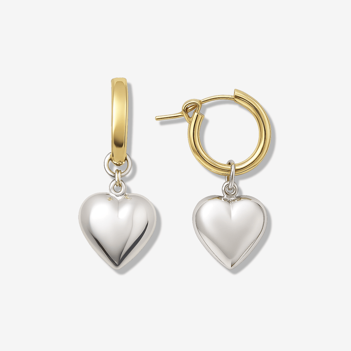 Two-tone hoop earrings with 14k gold filled hoops and sterling silver puffy heart charms on a clean background